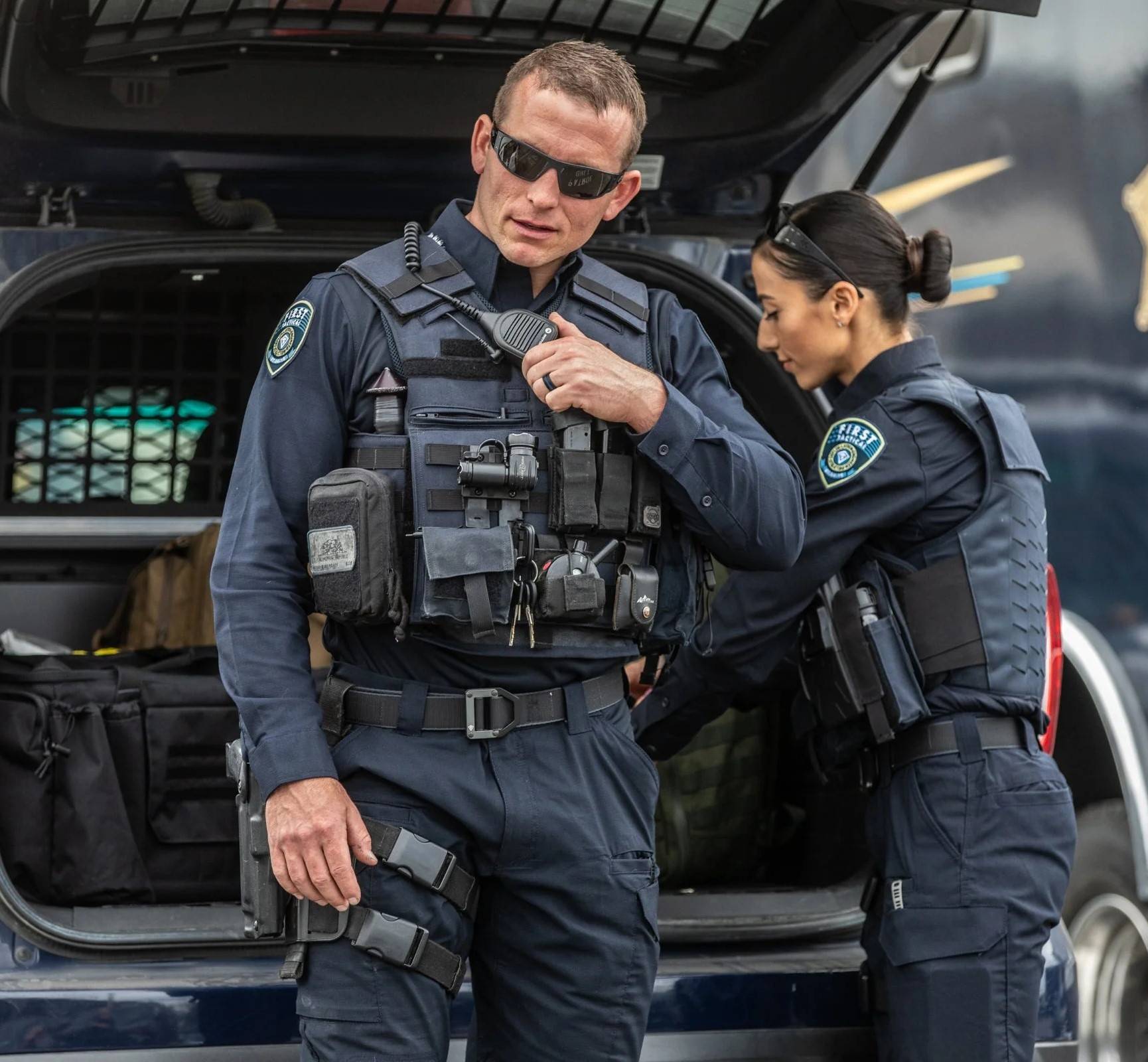 Two officers preparing with tactical gear